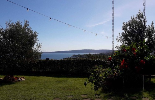 Lake Bracciano Villa | Breathtaking view of the lake and castle surrounded by holm oaks and oaks