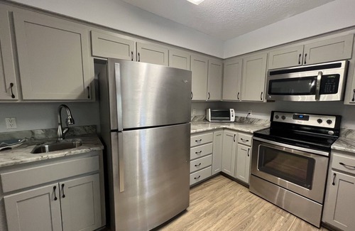Mount Ida Condo | Forest view, log-sided two bedroom, two bath condo on Lake Ouachita. by RedAwning