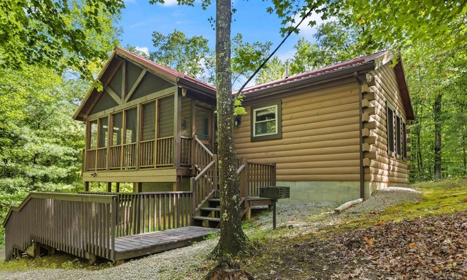 Zoe Cabin | Log Home with fenced in deck & screen porch, cosmopolitan style ranch design.