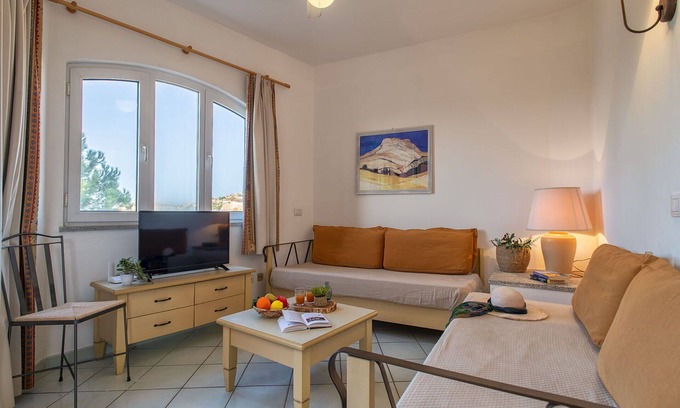 Canneddi Apartment | Lovely apartment for 4 guests with A/C, pool, WIFI, TV, terrace and pets allowed