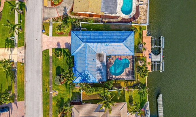 Cocoa Isles House | Luxury Canalfront Home w/Heated Pool, Game Room, Boat & Jet Ski Lifts