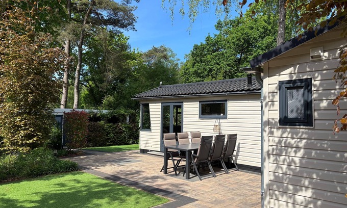 Lieren House | Veluwe Chalet featuring a charming veranda with a fire table.