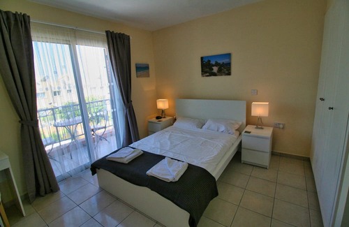 Peyia Town House | Direct access to the pool from the garden. A sandy beach is a few minutes away.