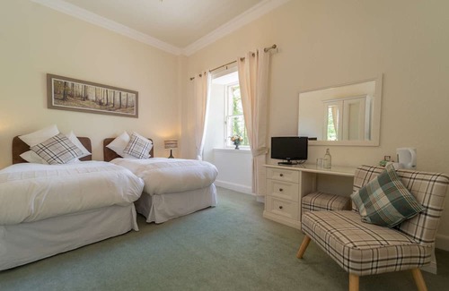Livingston Cabin | This spacious twin room, located on the first floor, boasts relaxing neutral decor,