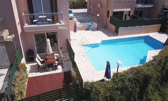 Peyia Town House | Direct access to the pool from the garden. A sandy beach is a few minutes away.